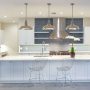 modern-beach-style-kitchen-with-polished-concrete-floors-white-cabinets-and-blue-subway-tile-backsplash